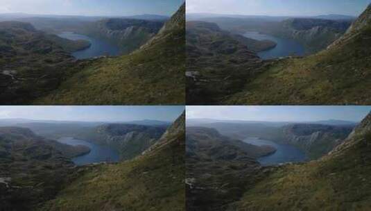 无人机拍摄了一个平静的湖泊，背景是绿色的高清在线视频素材下载