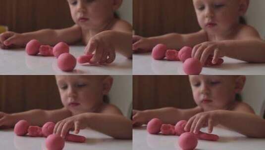 婴儿玩粉红色橡皮泥，早期与儿童一起塑造发高清在线视频素材下载