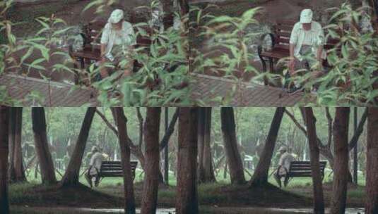 小雨中坐在公园长椅上的孤独老人高清在线视频素材下载