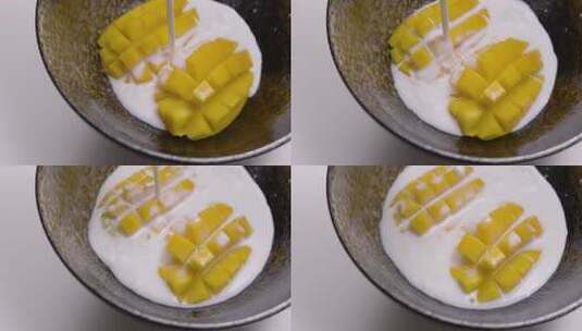 4K往芒果果粒倒牛奶液体高清在线视频素材下载