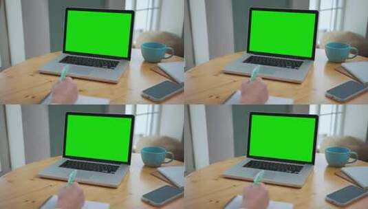 办公室人员使用带绿幕的笔记本电脑高清在线视频素材下载
