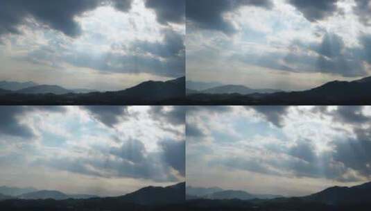 天空延时山峰阳光穿过云朵上帝之光丁达尔光高清在线视频素材下载