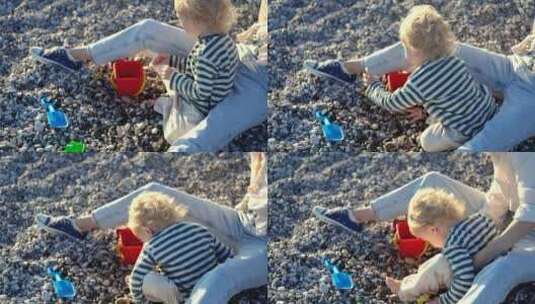 母子在卵石沙滩上玩耍高清在线视频素材下载