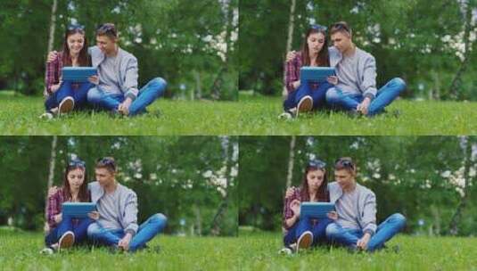 情侣坐在地上玩平板电脑高清在线视频素材下载
