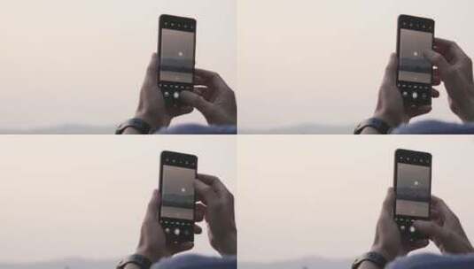 游客拿手机拍摄夕阳下西湖景色高清在线视频素材下载