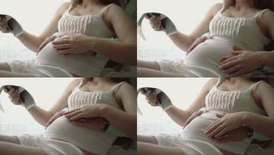 丈夫抚摸妻子怀孕的肚子高清在线视频素材下载