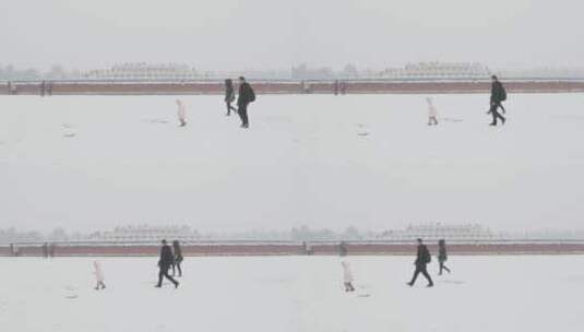 大雪天气中的天坛公园圜丘前经过的一家人高清在线视频素材下载