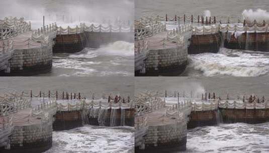威海金海湾栈桥冬季的大浪高清在线视频素材下载