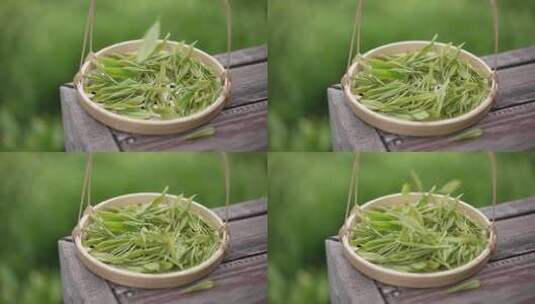 绿色新鲜茶叶掉落竹编篮子升格慢镜头高清在线视频素材下载