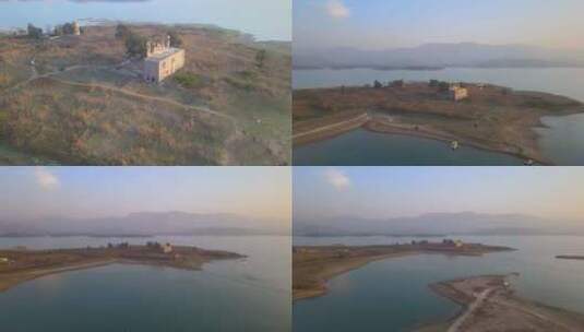 岛上旧建筑的鸟瞰图，日落时的旅游滑翔伞高清在线视频素材下载