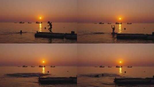 唯美海边日落夕阳下游泳玩水的小孩子高清在线视频素材下载