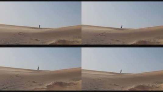 一位身着防风服妇女在沙漠中行走高清在线视频素材下载