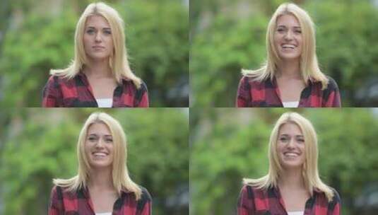 年轻快乐的金发女子在户外街道上微笑高清在线视频素材下载