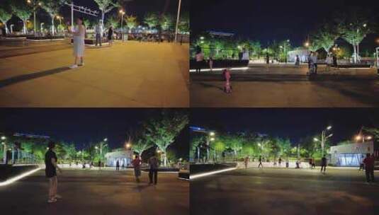 夜晚公园广场休闲散步跳舞的人们高清在线视频素材下载