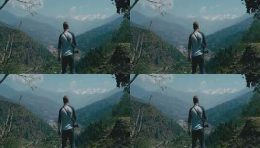 男人站在山顶看风景高清在线视频素材下载