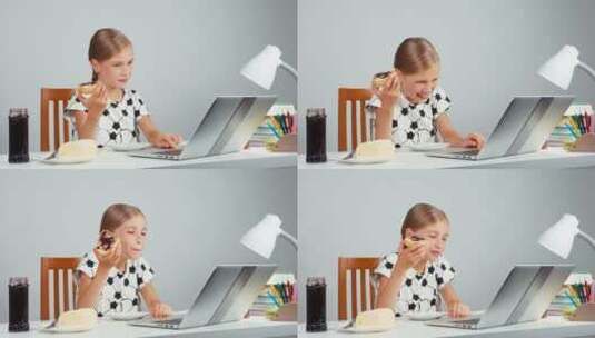 女孩笑着吃果酱黄油面包坐在笔记本电脑前高清在线视频素材下载