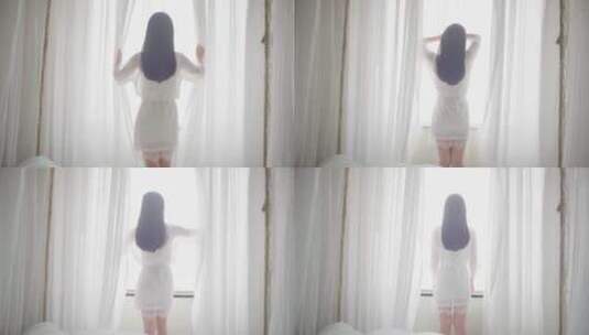 女生起床拉开窗帘看向窗外风景高清在线视频素材下载