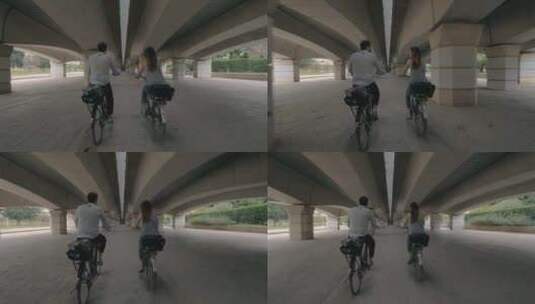 一男一女在天桥下骑自行车高清在线视频素材下载