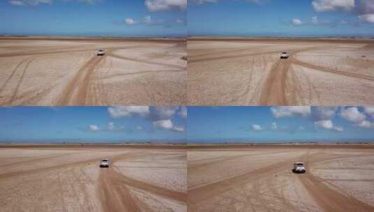 航拍沙漠中行驶的汽车高清在线视频素材下载