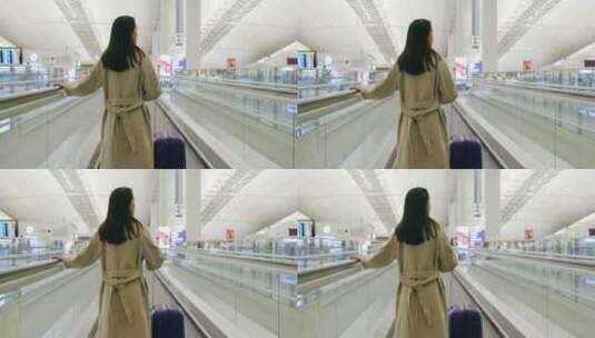 女人拉着手提箱在机场扶梯上高清在线视频素材下载