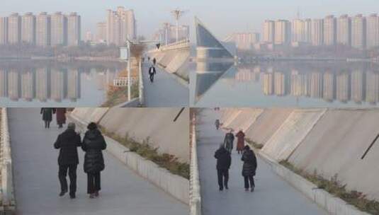 喀什吐曼桥上散步的人背影，江景摇镜头高清在线视频素材下载