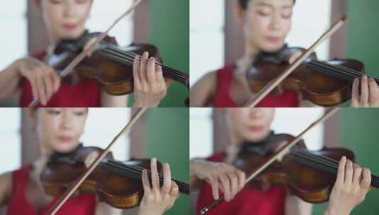 一个红衣女人在窗前拉小提琴的特写高清在线视频素材下载