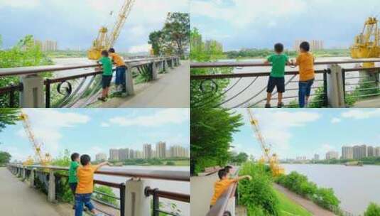 两个小孩在江边爬栏杆看风景高清在线视频素材下载
