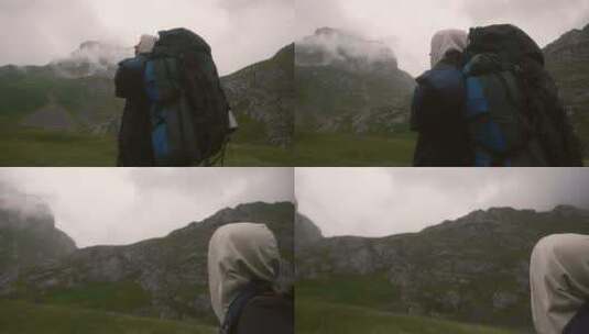在山脚观察山顶浓雾的男子高清在线视频素材下载