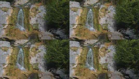 长满青苔的岩石上挂着一座小瀑布高清在线视频素材下载