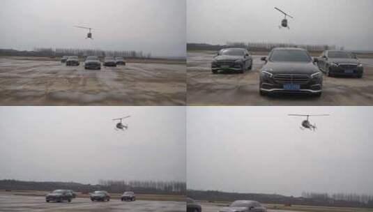 直升机飞行奔驰车队统一向前行驶4K高清在线视频素材下载