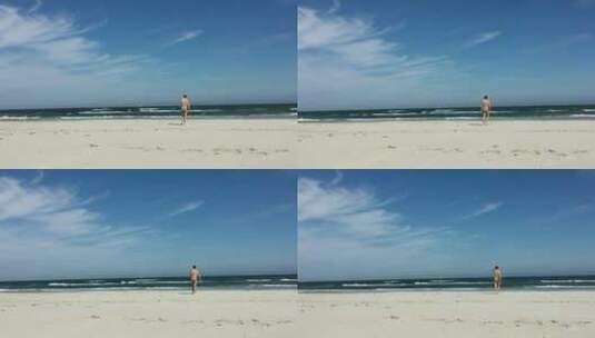 在海滩上散步的男人高清在线视频素材下载