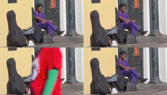 一个无家可归的音乐家坐在街上高清在线视频素材下载