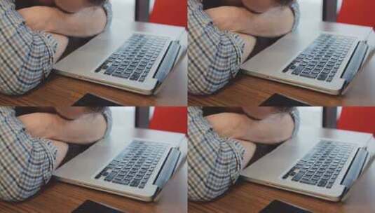 心烦意乱的男人把手放在笔记本电脑附近高清在线视频素材下载
