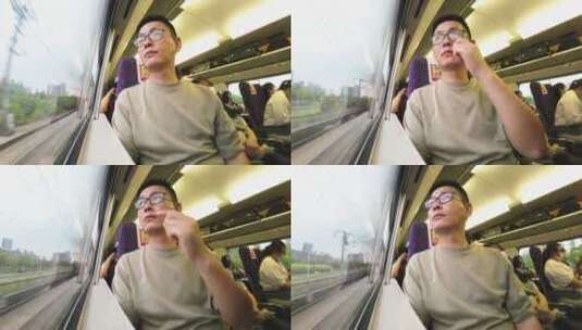 中年男性乘客在高铁上看着车外高清在线视频素材下载