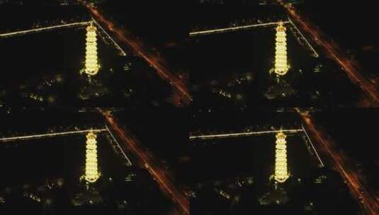 航拍：夜间古塔与笔直车道高清在线视频素材下载