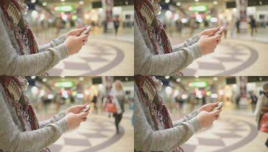 女孩在购物中心拿起智能手机手机高清在线视频素材下载