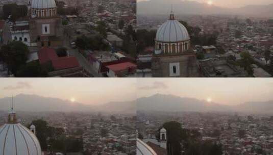 日落时分，无人机经过瓜达卢佩教堂，倾斜着，展示了圣克里斯托瓦尔德市高清在线视频素材下载