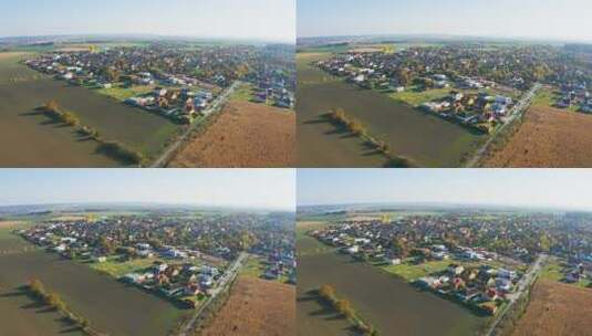 秋天，无人机在农村一个美丽的城镇拍摄彩色房屋高清在线视频素材下载