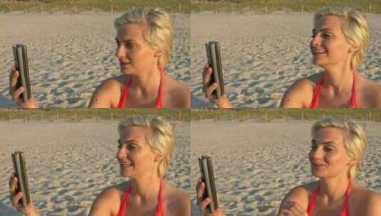 一个女人正在沙滩上视频通话高清在线视频素材下载