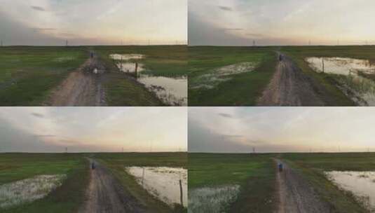 骑电动车行驶在泥泞的路上高清在线视频素材下载