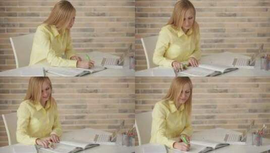 女孩坐在书桌前学习工作高清在线视频素材下载