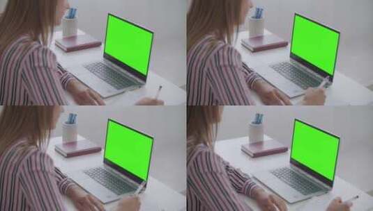 女人看绿屏笔记本电脑高清在线视频素材下载