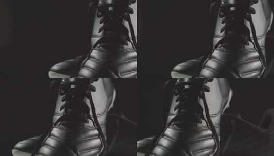 黑色背景前的足球靴特写镜头高清在线视频素材下载