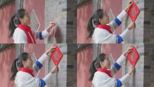 亚洲中国人女性女人过年贴春联贴福字高清在线视频素材下载