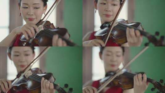 一个红衣女人在窗前拉小提琴的特写 (1)高清在线视频素材下载