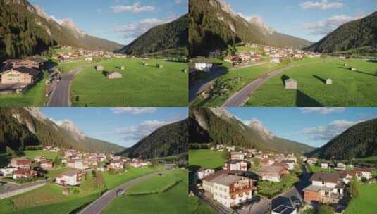日落阿尔卑斯山绿色山谷中奥地利村庄的鸟瞰图高清在线视频素材下载