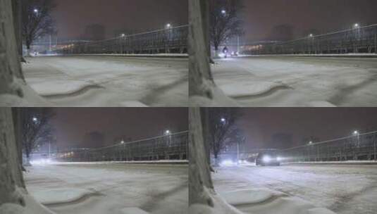 城市夜晚大雪街道路边行驶车流高清在线视频素材下载