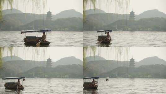 杭州西湖手摇船驶过远处是雷峰塔高清在线视频素材下载