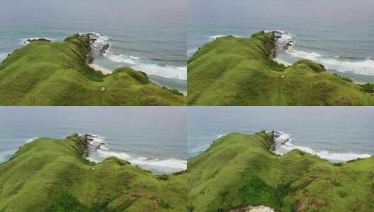 美丽的波浪绿色山丘高原海岸线在武吉Merese龙目岛，空中高清在线视频素材下载