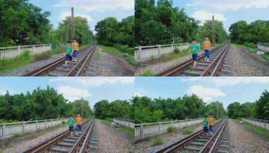 两个小孩走在铁路上玩耍高清在线视频素材下载